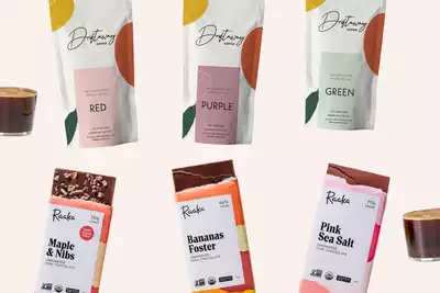 Image showcasing a selection of gourmet coffee and chocolate, featuring Driftaway Coffee bags labeled Red, Purple, and Green, alongside Raaka Chocolate bars in flavors such as Maple & Nibs, Bananas Foster, and Pink Sea Salt. Perfect for team-building events curated for HR professionals looking to provide a unique and engaging experience.