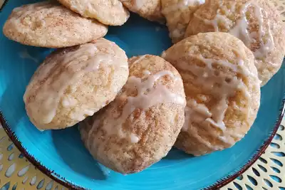 A plate of iced cinnamon cookies, perfect for a team-building baking activity designed to engage and delight HR professionals.